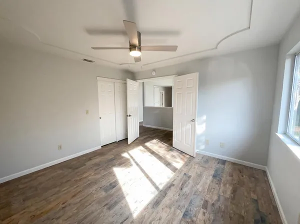 wooden floor in an empty room with a window