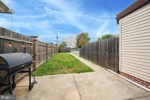 a view of backyard with outdoor seating and stairs