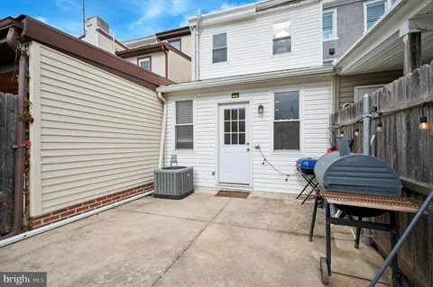 a backyard of a house with outdoor seating