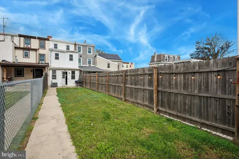 a view of a house with backyard and deck