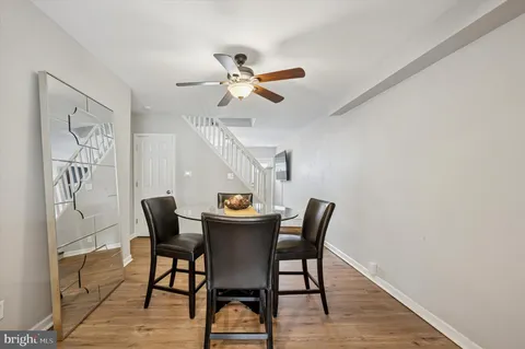 a view of a dining room with furniture and a chandelier fan
