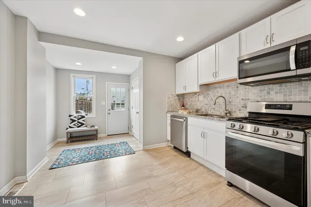 a kitchen with granite countertop a stove and a sink