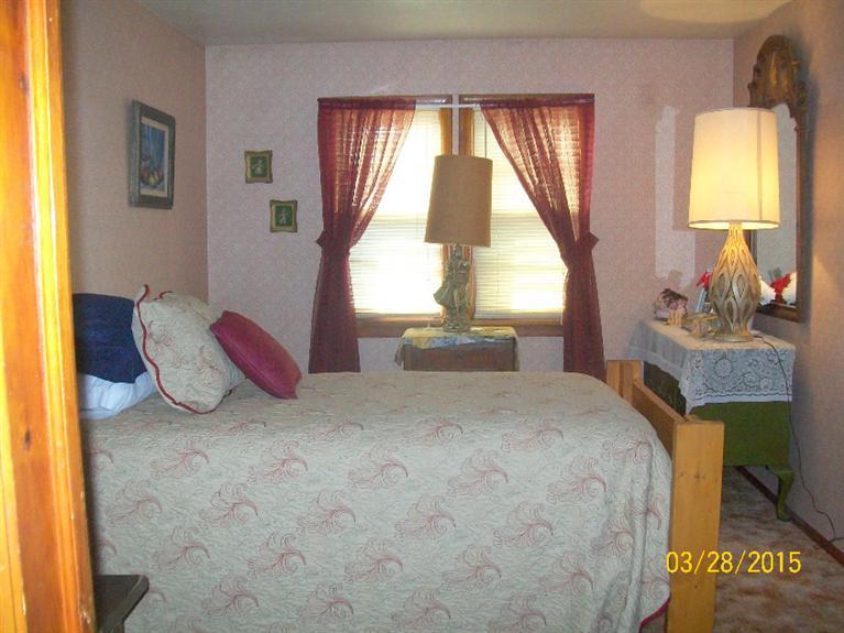 5015 Waldo Road Cave Junction, OR 97523 - Photo 19 of 35 a spacious bedroom with a bed and a window