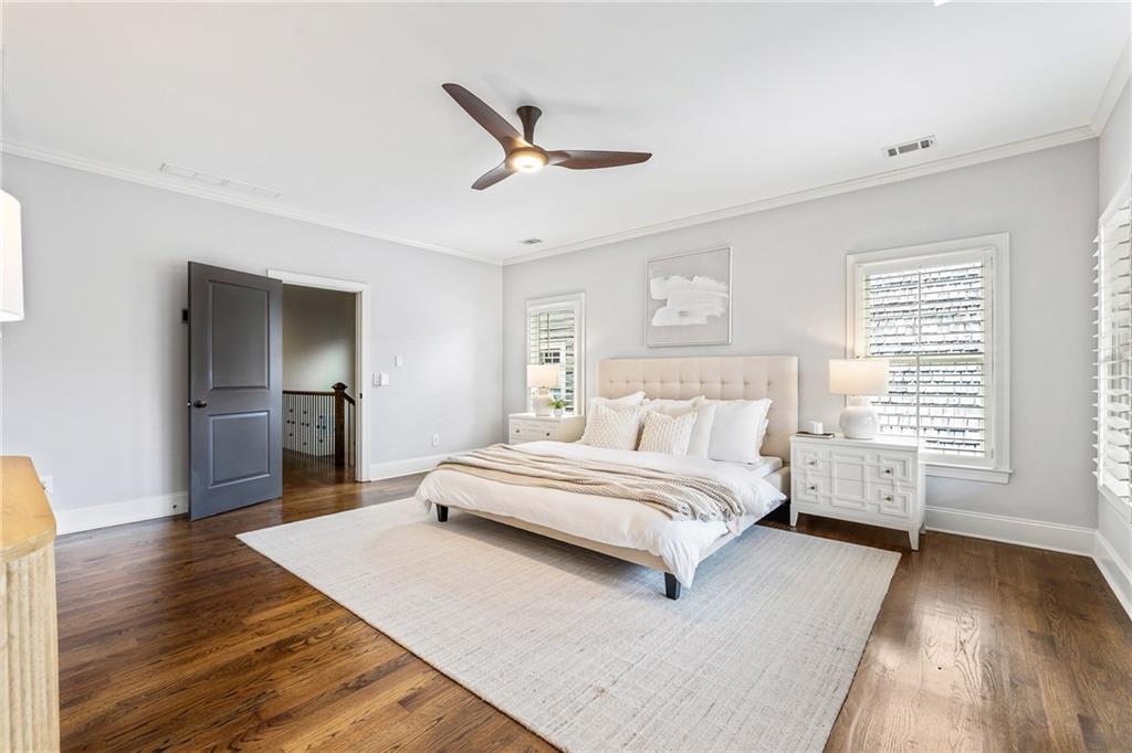 6645 Will Allen Road Cumming, GA 30040 - Photo 29 of 62 a spacious bedroom with a bed and a wooden floor