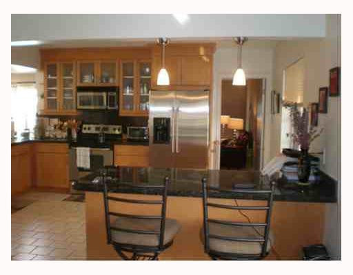 a kitchen view with granite countertop a window