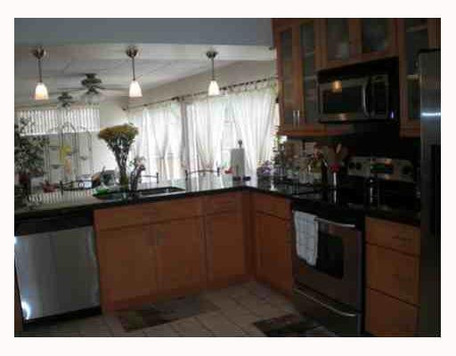 4315 Harrison Street Hollywood, FL 33021 - Photo 3 of 10 a kitchen with stainless steel appliances granite countertop a sink and a microwave