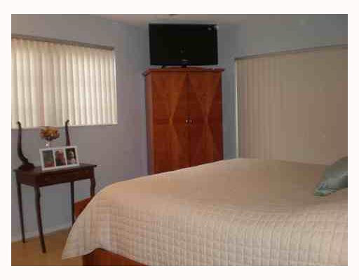 4315 Harrison Street Hollywood, FL 33021 - Photo 9 of 10 a bedroom with a bed and a flat screen tv