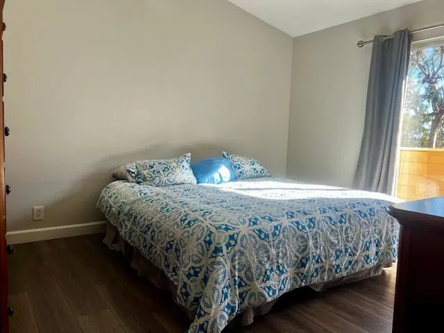 a bed sitting in a bedroom next to a window