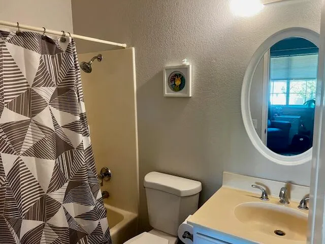 a bathroom with a sink and mirror with toilet