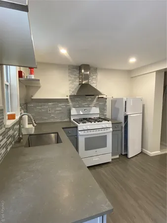 a kitchen with refrigerator and stove