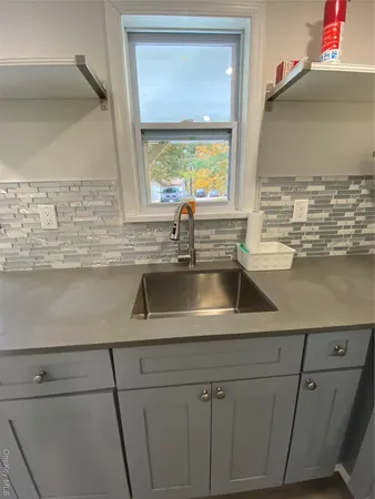 a kitchen with a sink and a window