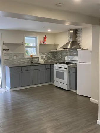 a kitchen with stainless steel appliances granite countertop a stove and a sink