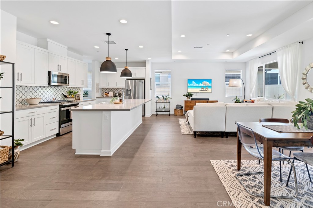 32037 Sedge Way Temecula, CA 92591 - Photo 12 of 61 a living room with stainless steel appliances kitchen island granite countertop furniture a sink a counter top space and a center island