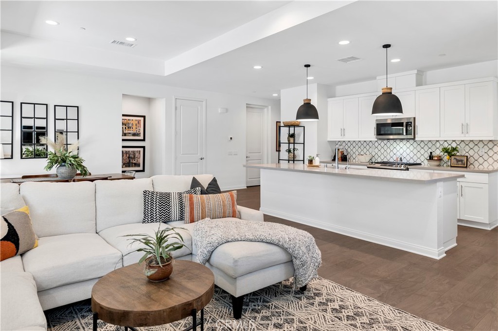 32037 Sedge Way Temecula, CA 92591 - Photo 13 of 61 a living room with furniture kitchen view and a chandelier