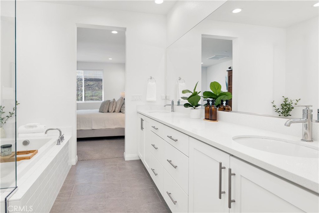 32037 Sedge Way Temecula, CA 92591 - Photo 28 of 61 a spacious en suite bathroom with a granite countertop tub and 2 sink mirror