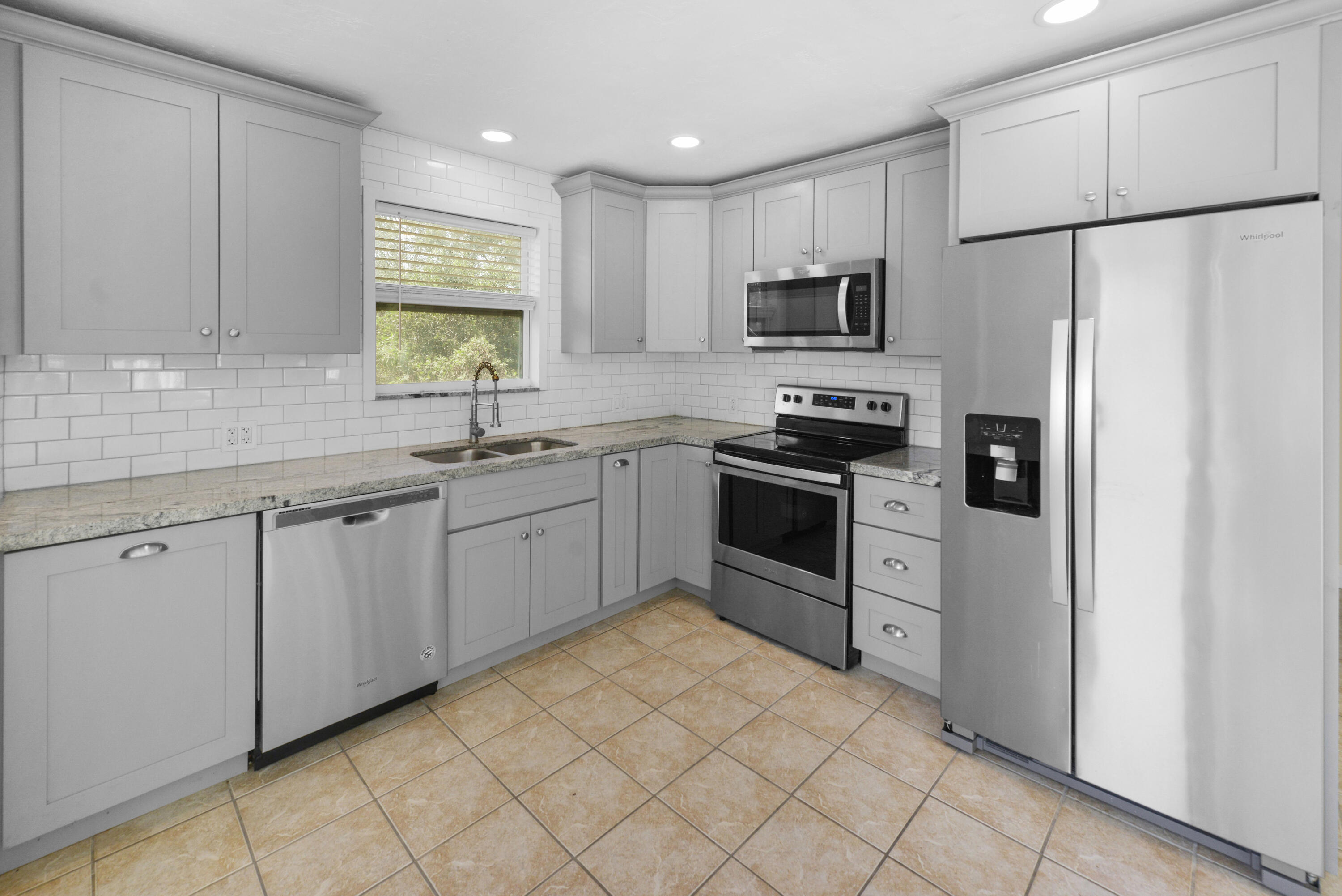 30868 Malaga Lane Big Pine Key, FL 33043 - Photo 18 of 34 a kitchen with white cabinets stainless steel appliances and a sink