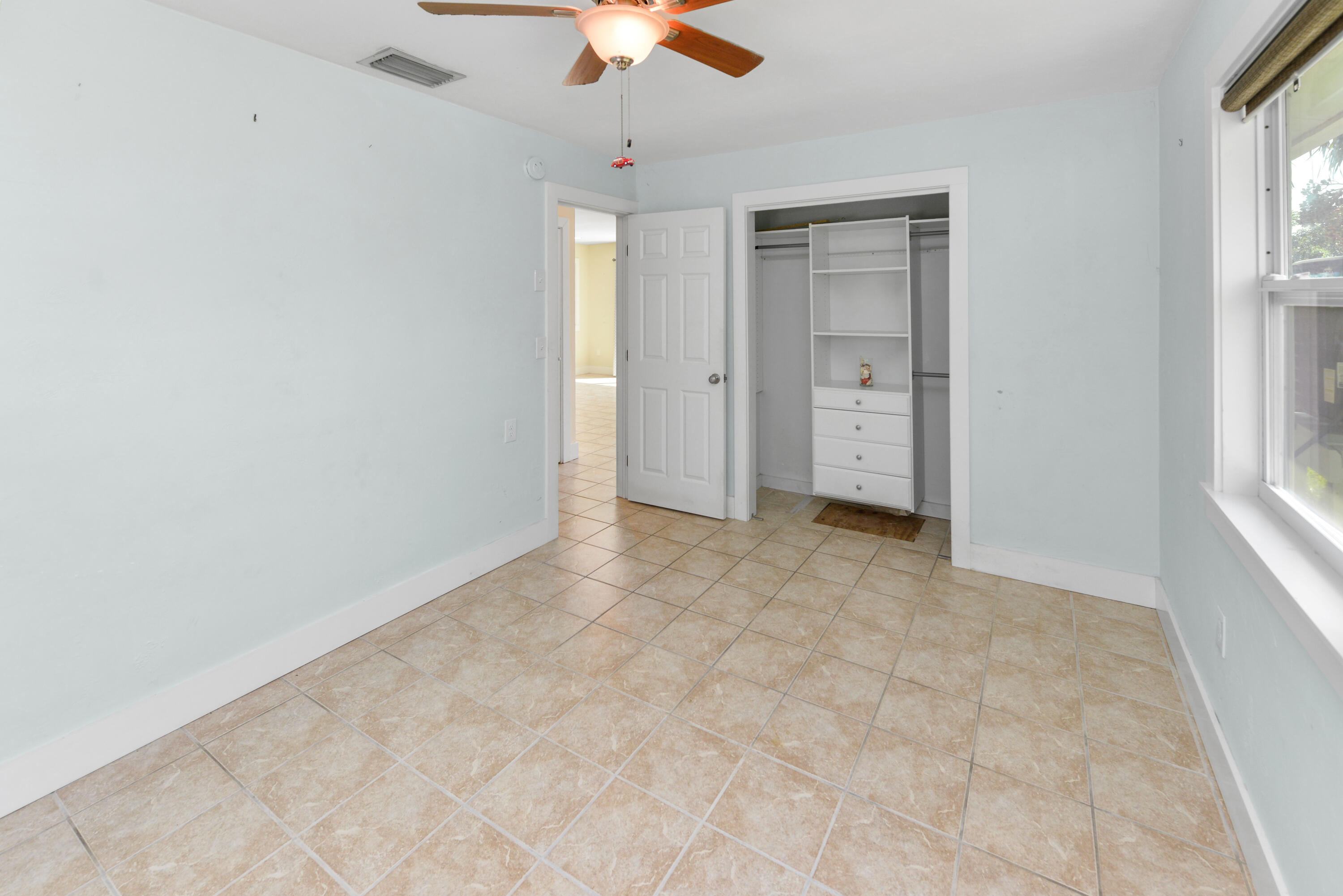 30868 Malaga Lane Big Pine Key, FL 33043 - Photo 21 of 34 an empty room with chandelier fan and windows