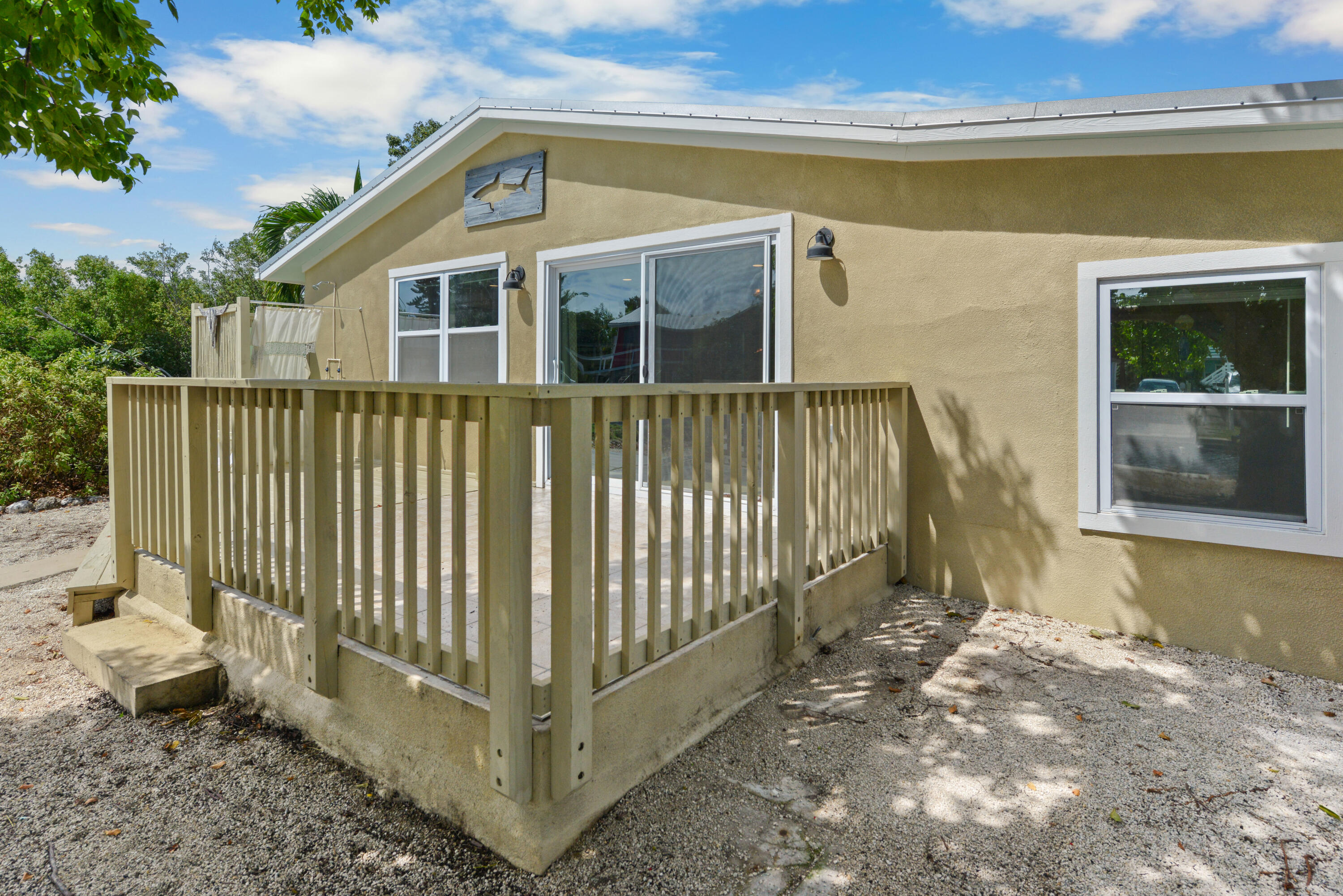 30868 Malaga Lane Big Pine Key, FL 33043 - Photo 27 of 34 a view of a house with a small yard and wooden fence