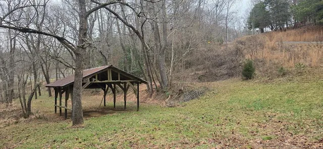 a view of a wooden house with a yard