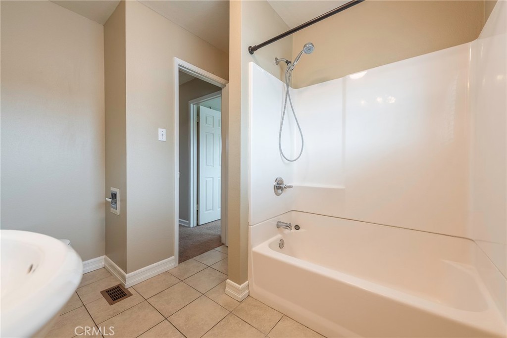 4697 Sierra Street Riverside, CA 92504 - Photo 33 of 51 a bathroom with a bathtub and shower