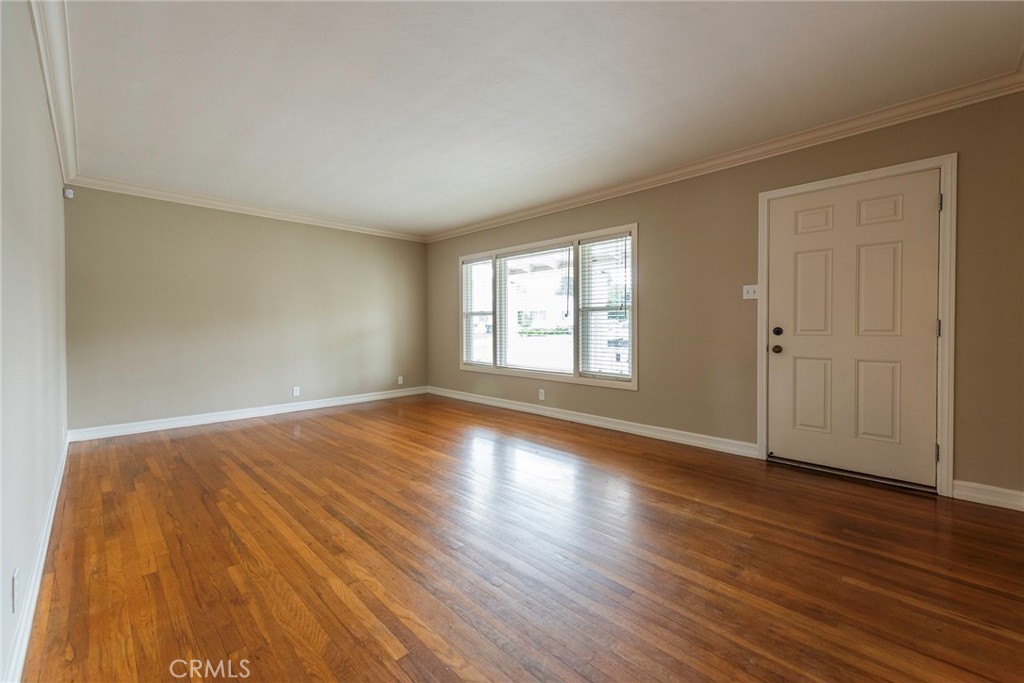 4697 Sierra Street Riverside, CA 92504 - Photo 8 of 51 an empty room with wooden floor and windows