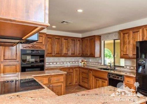 34480 Sycamore Springs Road Hemet, CA 92544 - Photo 6 of 24 a kitchen with a stove a sink and a microwave