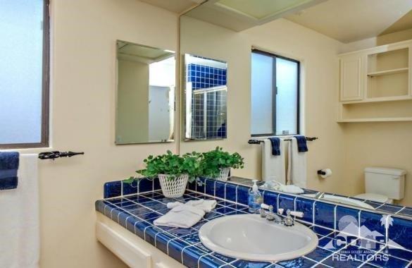 34480 Sycamore Springs Road Hemet, CA 92544 - Photo 7 of 24 a bathroom with a granite countertop sink a mirror and shower