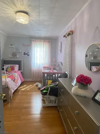 a bedroom with a bed and a chandelier