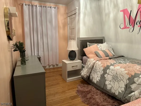 a bedroom with a bed and a mirror