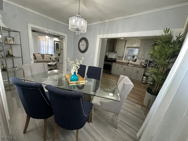 a view of a dining room with furniture and a chandelier