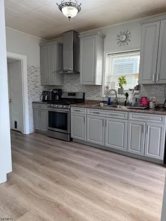 a kitchen with stainless steel appliances granite countertop a stove and a sink