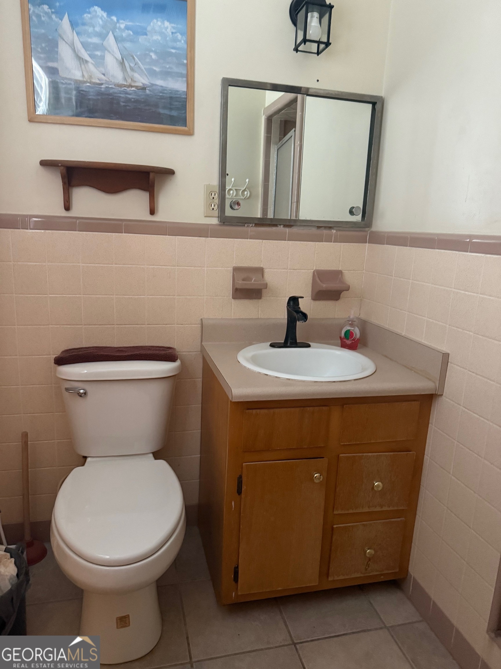 45 Elton Street Hazlehurst, GA 31539 - Photo 13 of 14 a bathroom with a toilet a sink and mirror
