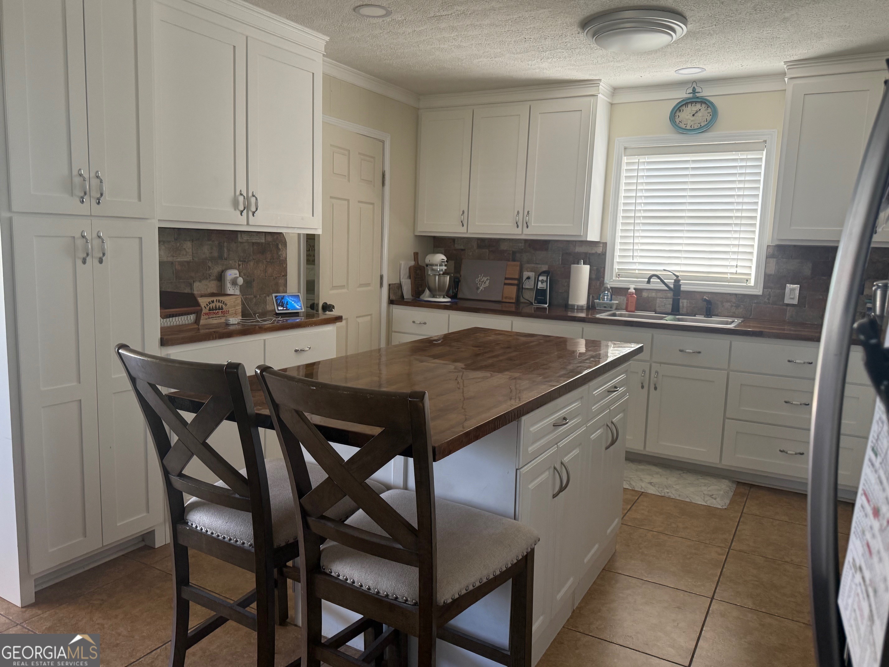 45 Elton Street Hazlehurst, GA 31539 - Photo 6 of 14 a kitchen with stainless steel appliances granite countertop a table chairs sink and cabinets