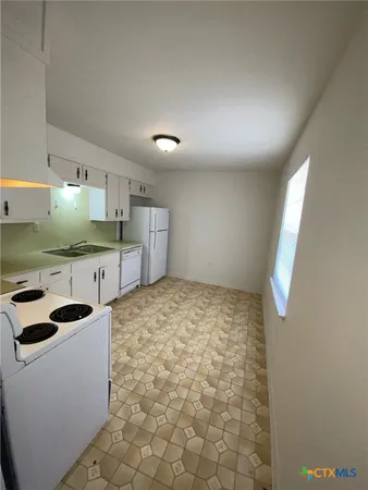 a kitchen with stainless steel appliances a cabinets and a sink