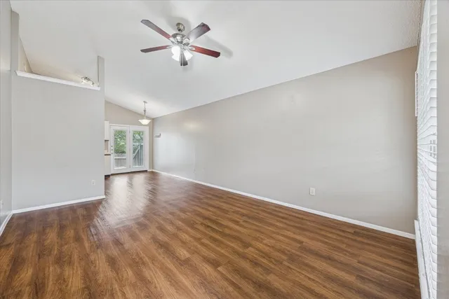 wooden floor in an empty room with a window