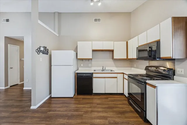 a kitchen with a sink a stove and refrigerator