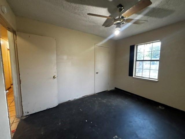 122 Rosa Street Edna, TX 77957 - Photo 16 of 17 an empty room with windows and fan
