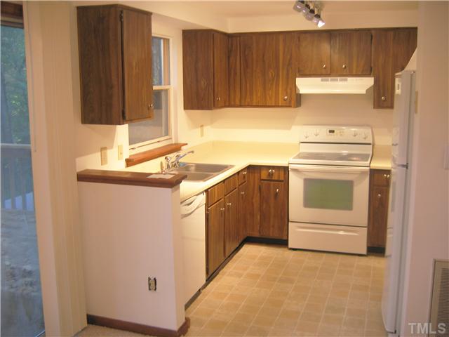 7334 Shellburne Drive Raleigh, NC 27612 - Photo 4 of 19 a kitchen with a sink and a stove top oven