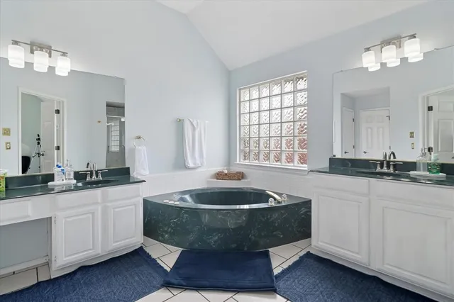 a kitchen with a stove sink cabinets and microwave