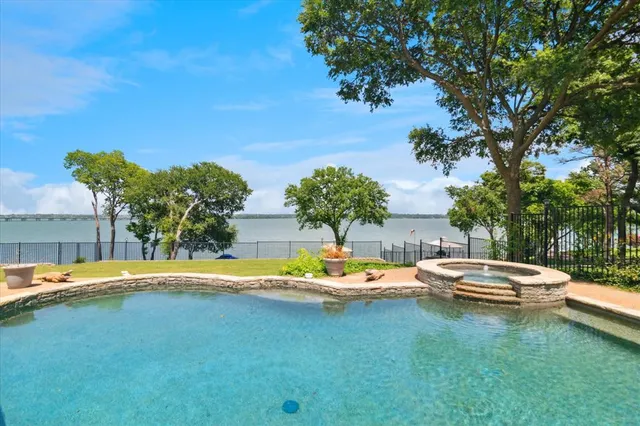 a view of swimming pool with outdoor seating and plants