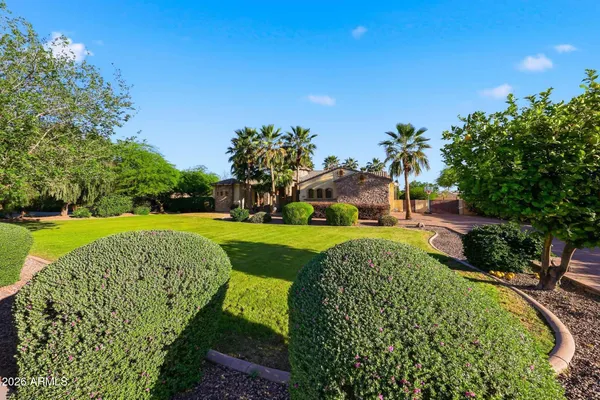 a bathroom with a granite countertop bathtub sink vanity and mirror