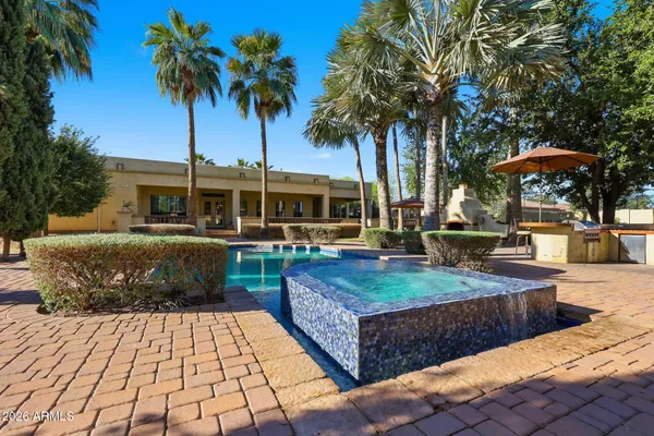 a front view of a house with swimming pool having outdoor seating