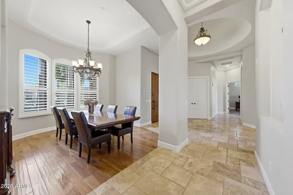 a dining room with furniture water view and a floor to ceiling window