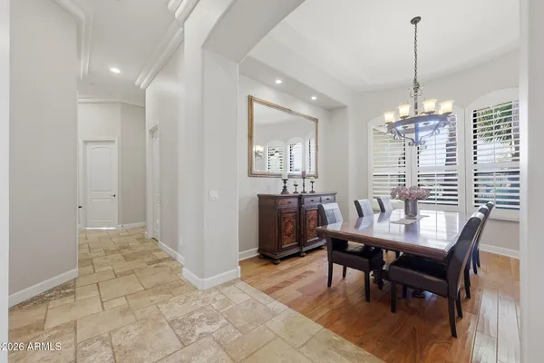 a view of a patio with table and chairs and wooden floor