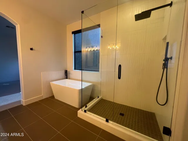 a bathroom with a tub and a shower
