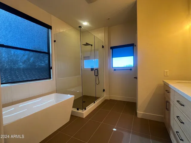 a bathroom with a tub a sink and a shower