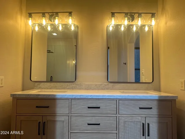 a bathroom with a sink vanity and a mirror
