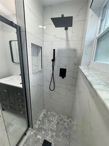 a large white kitchen with a sink stainless steel appliances and cabinets