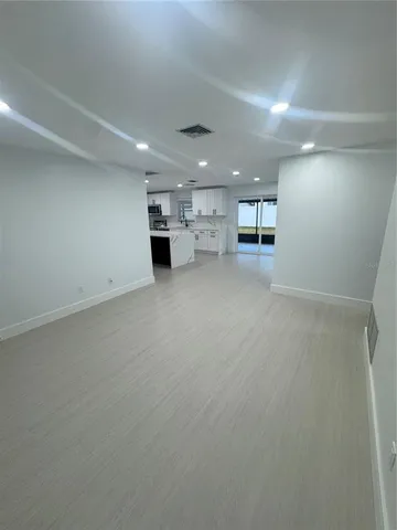 an empty room with windows and pillars in it