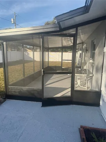 a kitchen with granite countertop a sink stainless steel appliances and white cabinets